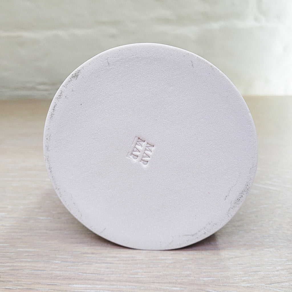 base view showing the MapMap makers mark on the Large Flat Top Cone Vase decorated using stencils and slip colours. With a distinctively mid-centurary modern feel about it - this piece is predominently white background and navy with red, blue and peach accents and a yellow top section.