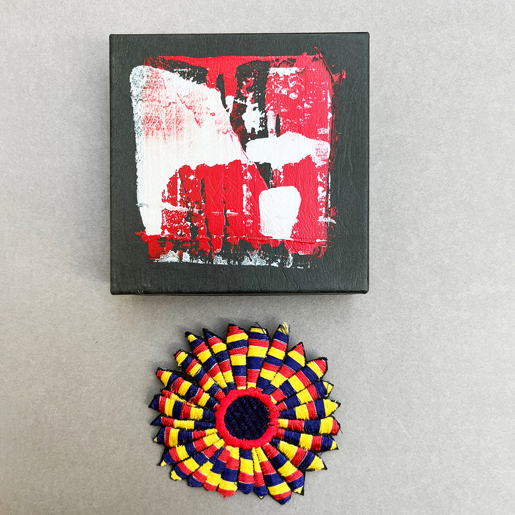 beautiful machine embroidered rosette brooch  by Michael Brennand -Wood.  Shown next to it's unique hand-painted presentation box.