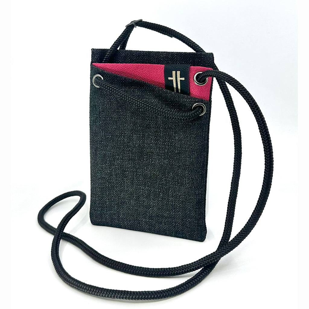 Mini 'portable pocket' bag crafted from reclaimed upholstery textiles and blinds in dark grey with a fuchsia accent