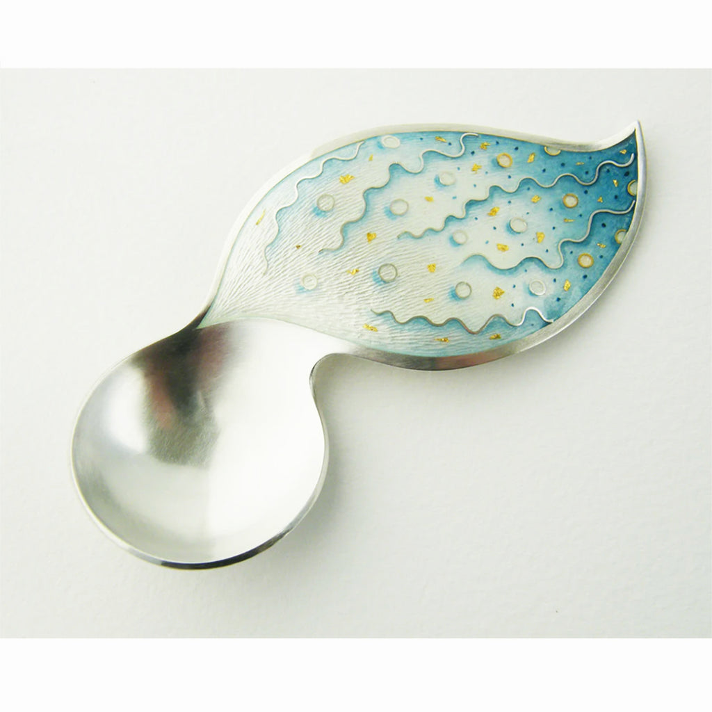 'Fizz' Spoon - this piece is formed by hand with hammers, and the enamel area on the handle is then hand engraved. Following from this the piece is enamelled and cloisonné wires alongside painted enamel details complete the design. By contemporary Silversmith Ruth Ball