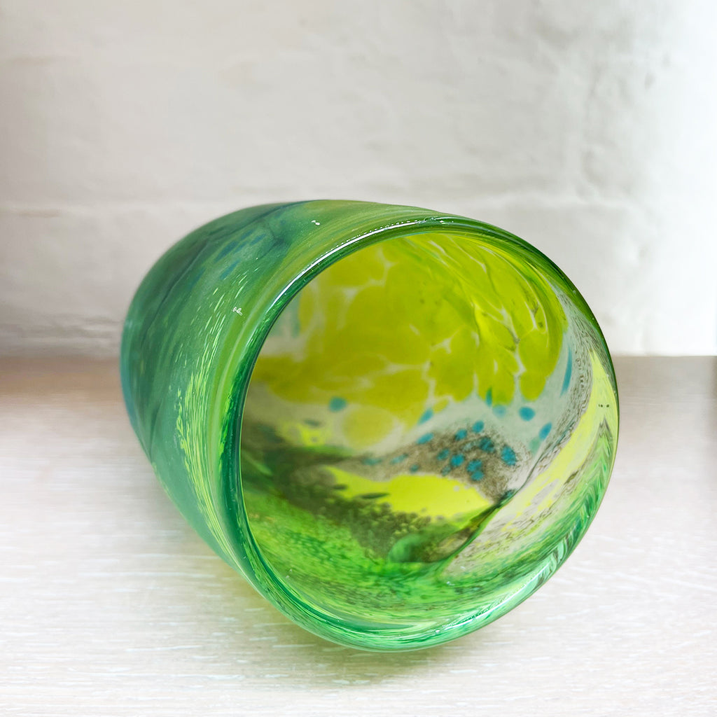 A peak inside a Green glass vase from Will Shakspeare's 'Random Trails' range, inspired by walking in the Elan Valley in Wales.  This vase is predominently green with varying shades, plus blue and yellow highlights