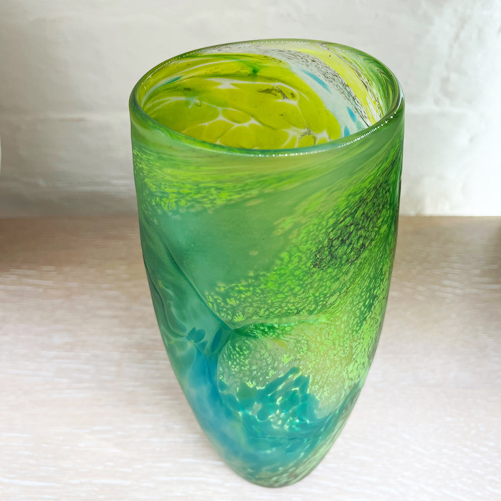 Green glass vase from Will Shakspeare's 'Random Trails' range, inspired by walking in the Elan Valley in Wales.  This vase is predominently green with varying shades, plus blue and yellow highlights