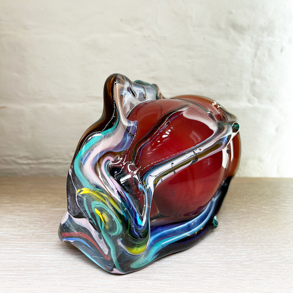 Base view of a stunning bowl by contemporary glass artist Will Shakspeare. The piece is inspired by trees and is predominantly red in colour with 'roots' in blues and a kaleidoscope of colours.