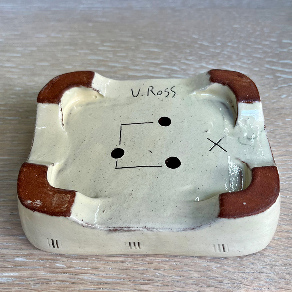 Base of Blue soap dish, decorated with figurative illustrations using coloured slips, brushwork, stencils and sgraffito on red earthenware showing the Maker's Mark of Contemporary Ceramicist Vivienne Ross