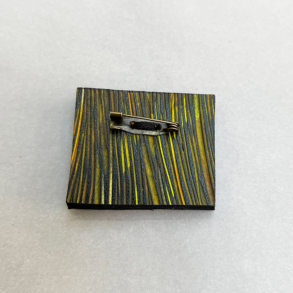 rear of multi-coloured hand painted leather brooch by Janine Partington