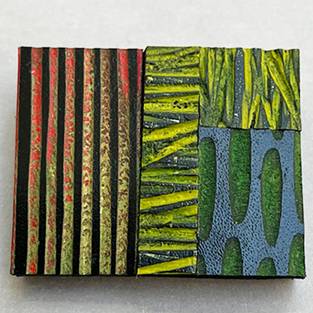 close up of multi-coloured hand painted leather brooch by Janine Partington
