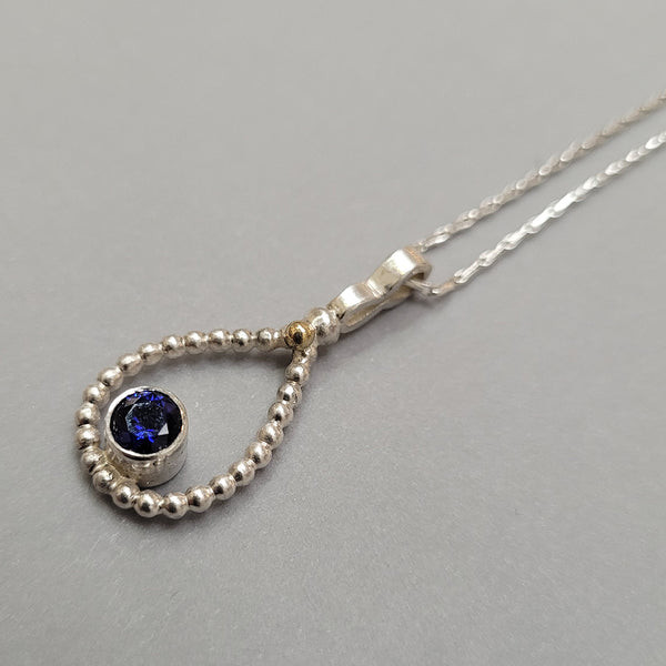 silver teardrop pendant with sapphire and 18ct gold feature on 22inc chain