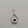 reverse side of silver teardrop pendant with sapphire and 18ct gold feature on 22inc chain