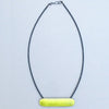 bright acid yellow necklace with a long horizontal textured shape partly enamelled strung on cable with tiny gunmetal colour glass seed beads by Annabet Wyndham