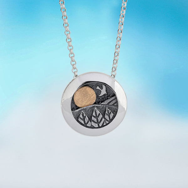 kinetic pendant by Alan Ardiff contemporary Irish jewellery - made of silver with an 18kt Gold sun, the design features a rising and setting sun to appreciate the rolling landscape of a beautiful day