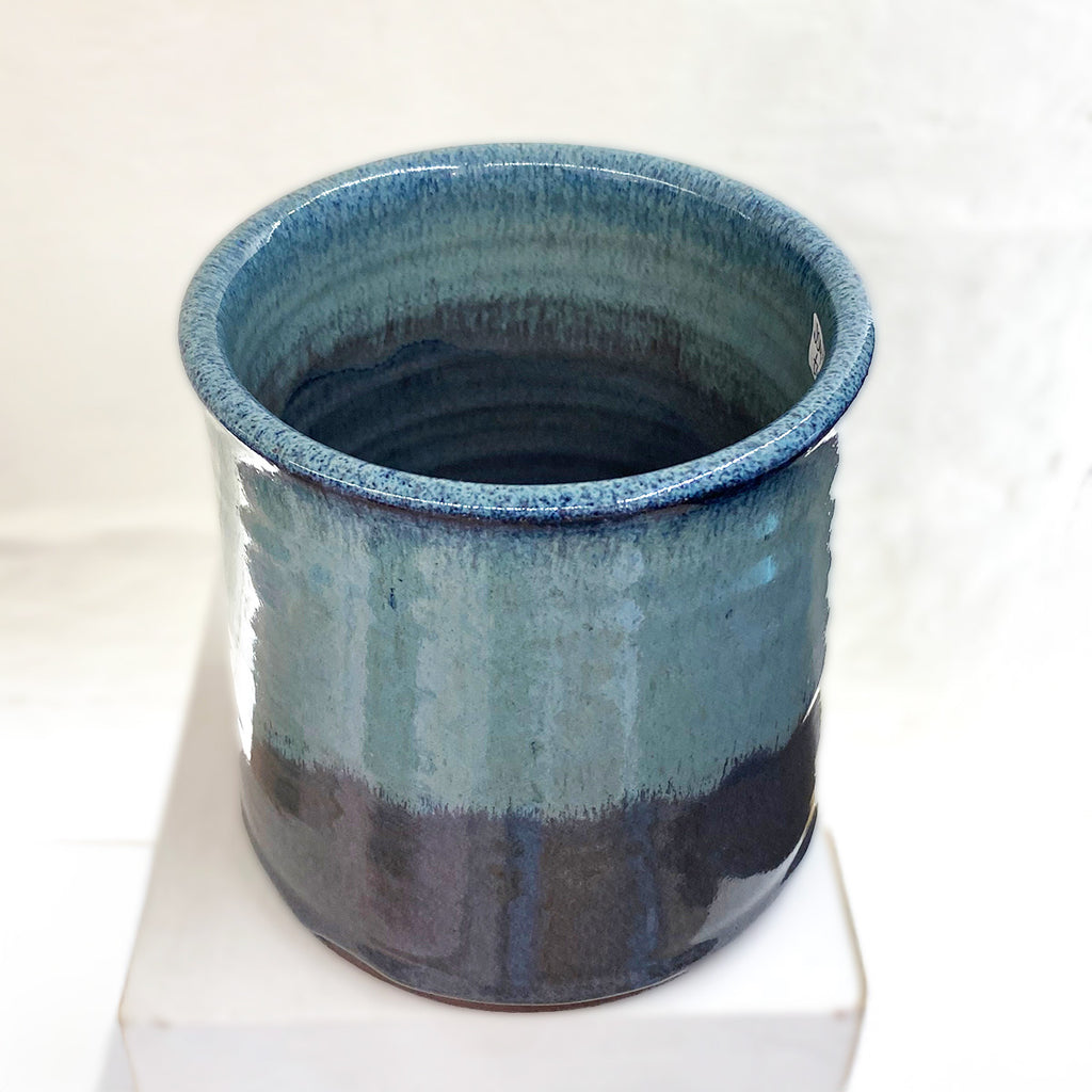 Top view of beautiful hand thrown blue gradient medium vase, with a single swallow at the center point by Julia Smith Ceramics