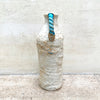 Handle side view of a ballclay rough textured bottle vase with a blue stoneware twisted handle by contemporary ceramicist John Kershaw