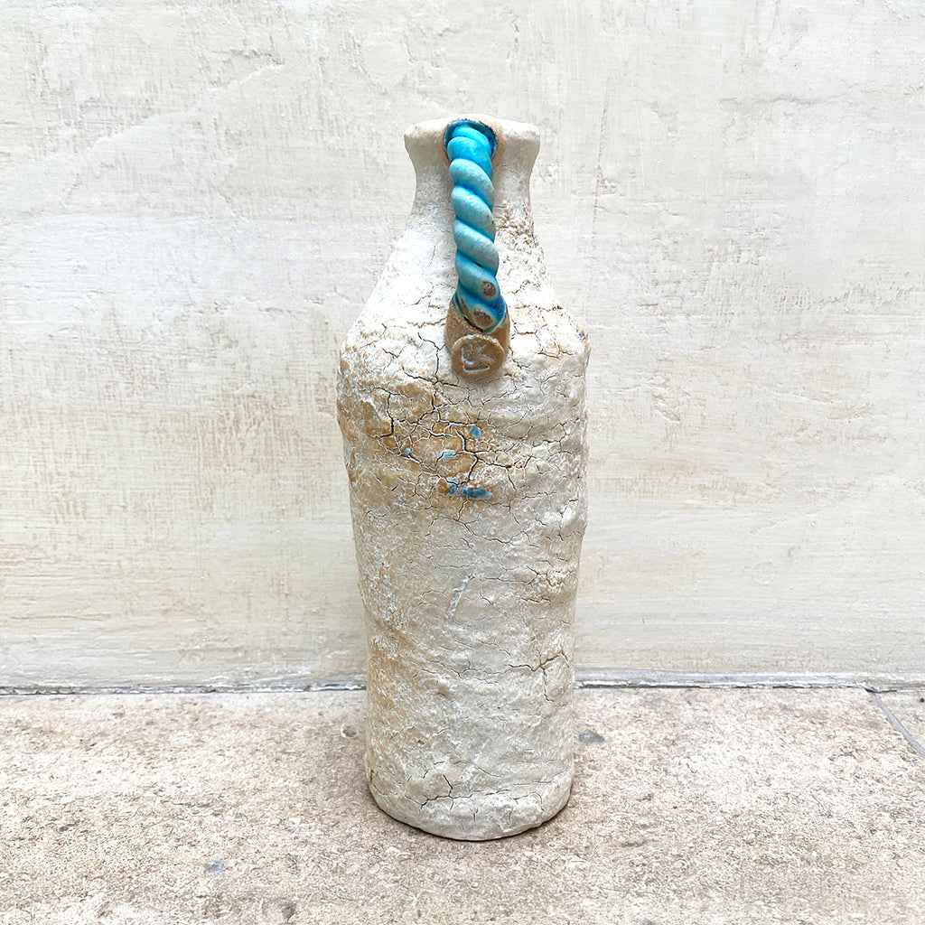 Handle side view of a ballclay rough textured bottle vase with a blue stoneware twisted handle by contemporary ceramicist John Kershaw