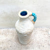 View from above of a ballclay rough textured bottle vase with a blue stoneware twisted handle by contemporary ceramicist John Kershaw