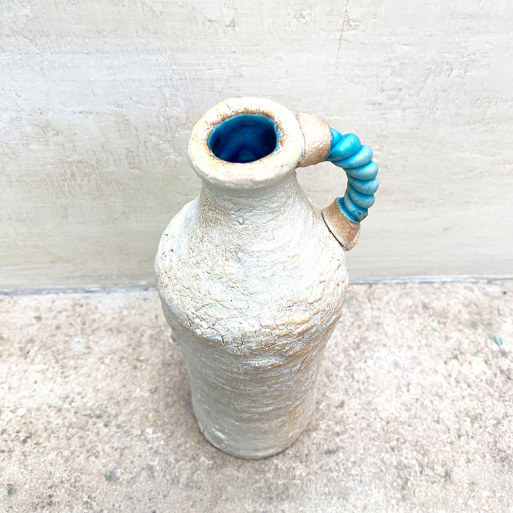 View from above of a ballclay rough textured bottle vase with a blue stoneware twisted handle by contemporary ceramicist John Kershaw