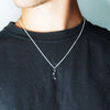Person in Black TShirt wearing Cascade 1 Pendant in Silver with moissanite by Contemporary Jeweller Sam Holmes
