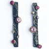 Close up of sterling silver drop studs with texture and pink sapphire, ruby and lab diamonds by Contemporary Jeweller Sam Holmes