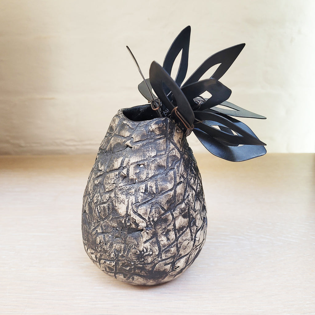Ceramic & Oxidised Copper Vessel by Sarah Kirk on display at The Bluecoat Display Centre, home of contemporary ceramics and design led gifts. this image shows the side view of the piece