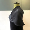 side view of Charcoal Shrug by Nawal Gebreel on a mannequin at Bluecoat Display Centre
