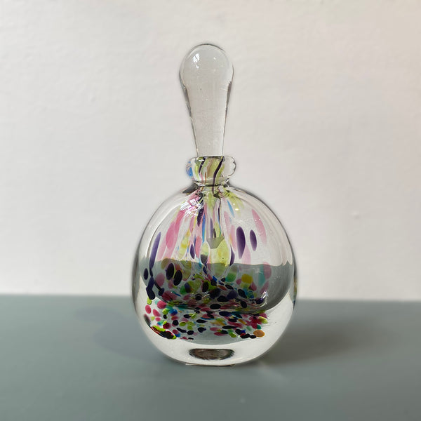 glass bottle in the design of a perfume bottle in a multicolored pebble splatter design crafted by Jane Charles