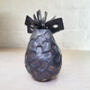 back view of contemporary ceramic vessel made from oxidised copper & clay. This piece features organic square shaped adornments and a dark glaze.
