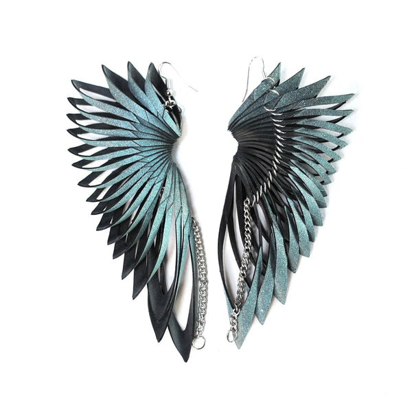 Pair of sculptural rubber earrings by Emma Ware on white background