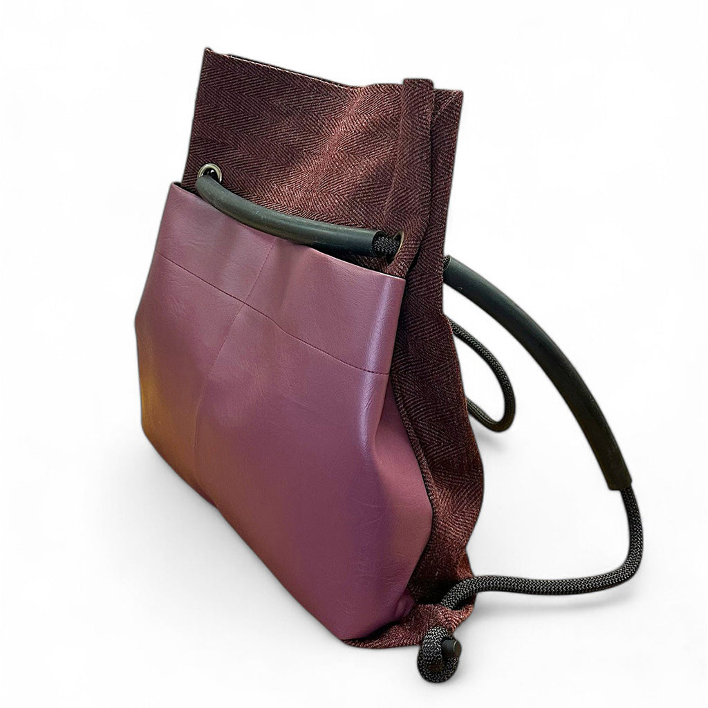 Plum convertible backpack from reclaimed materials by Studio Ditto