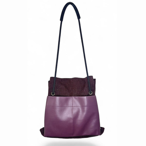 Plum convertible backpack from reclaimed materials shown hanging by Studio Ditto
