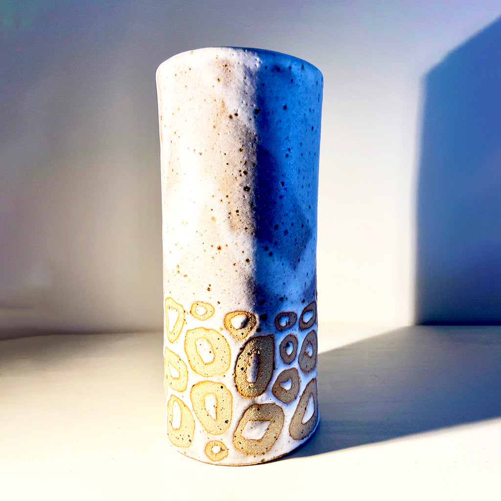 cylindrical vase in flecked stoneware clay, simply finished with a loosely applied off-white matte glazeby Contemporary Ceramicist Sarah Bartlem