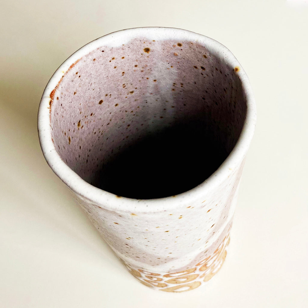 top view of cylindrical vase in flecked stoneware clay, simply finished with a loosely applied off-white matte glazeby Contemporary Ceramicist Sarah Bartlem