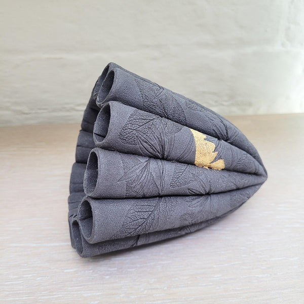 left side view of contemporary ceramic dark leaf pod by Ellul Ceramics featuring 24ct gold leaf