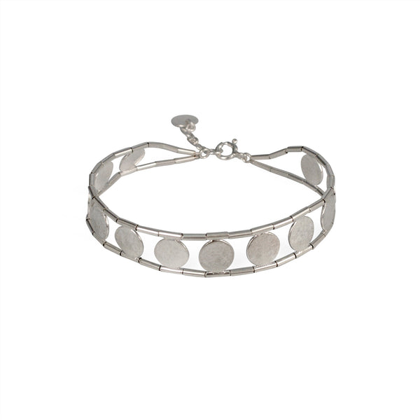 silver bracelet with a beaded exterior and silver discs connecting the piece together by Cara Tonkin