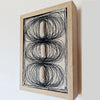 textile design with monochromatic stitches and fabric, creating three ovals that pop out of the canvas by Contemporary irish textile artist Patricia Kelly