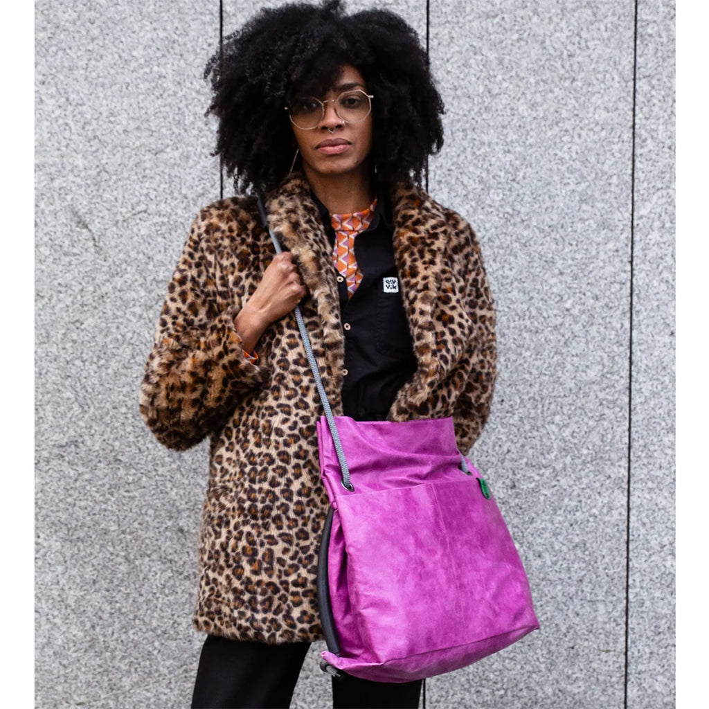Studio Ditto Fuchsia Pink Faux Leather bag worn as a tote by model in a leopard print coat