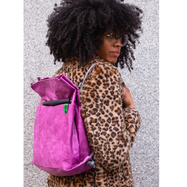 Studio Ditto Fuchsia Pink Faux Leather bag worn as backpack by model in a leopard print coat