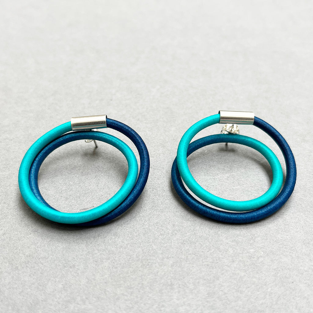 contemporary blue green double loop earstuds are the perfect way to add a pop of colour to any outfit. In silver and hand dyed elastic by Gilly Langton