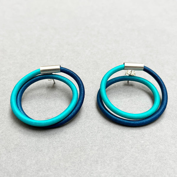 contemporary blue green double loop earstuds are the perfect way to add a pop of colour to any outfit. In silver and hand dyed elastic by Gilly Langton