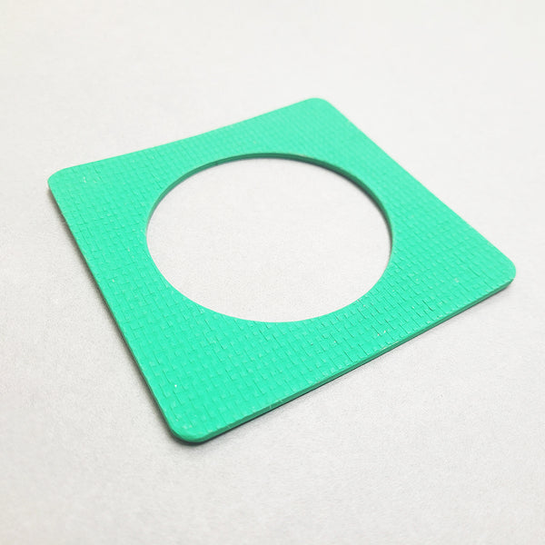 Green square bangle inspired by the Bauhaus design movement. Made from linoleum and hand painted. Shown on an angle
