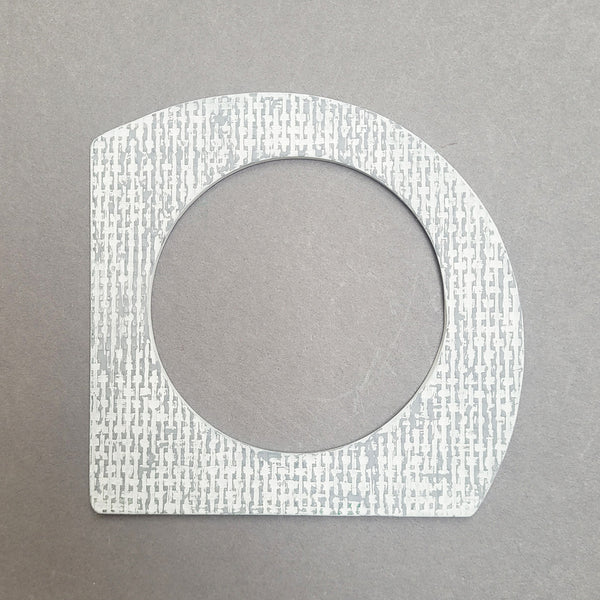 White and grey A-shaped bangle inspired by the Bauhaus design movement. Made from linoleum and hand painted by Studio Ditto in Liverpool