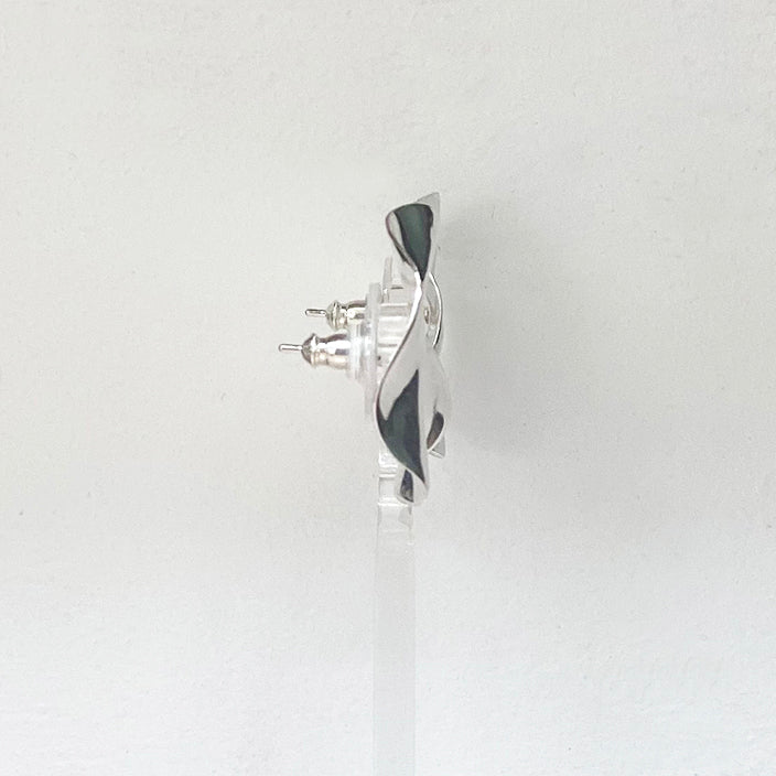 Side view of A beautiful pair of hammered round earrings crafted from sterling silver by Irish Silversmith Kevin O’Dwyer.