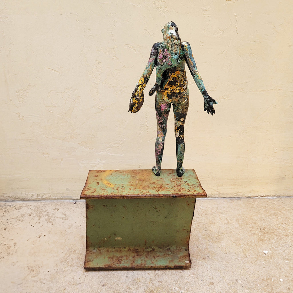 rear of Johnny Vegas sculpture  A figure mounted on a salvaged RSJ steel girder. The nylon figure has been patinated using bleach which creates amazing colours, with highlights of silver and gold leaf.