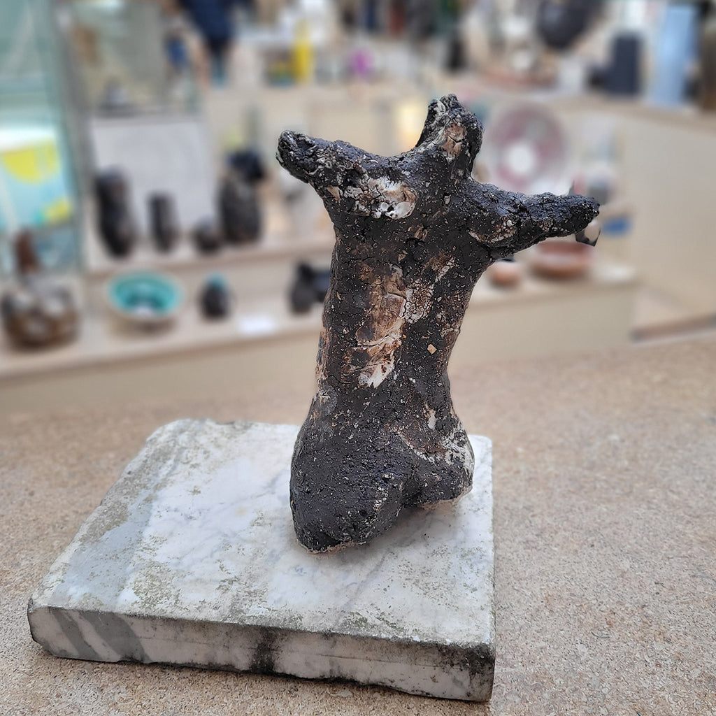 Johnny Vegas Female torso sculpted from black clay and mounted on a salvaged stone base - rear view in situ at Bluecoat Display Centre Liverpool