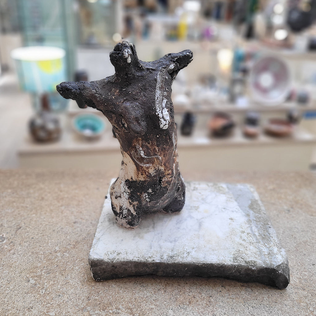 Johnny Vegas Female torso sculpted from black clay and mounted on a salvaged stone base