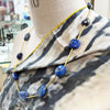 Lapis lazuli and brass necklace with a handmade brass catch by local maker Kate Moult. Photographed on a manequin over a scarf