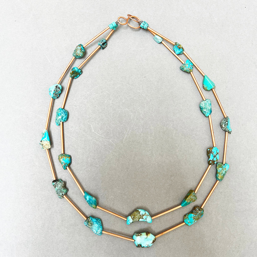 Turquoise and copper necklace with a handmade copper catch by Liverpool maker Kate Moult. This is a gorgeous double stranded necklace photographed on a grey background 