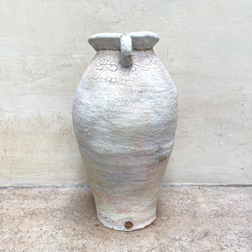 side view of pale ballclay stoneware vase with a crackled texture and two small handles at the sides by contemporary ceramicist John Kershaw at Bluecoat Display Centre