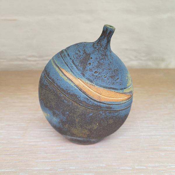a stunning piece of contemporary ceramic featuring texture, deep blues and ochres. Held inside this small stoneware bottle are porcelain seashells which give a gentle rattle when shaken