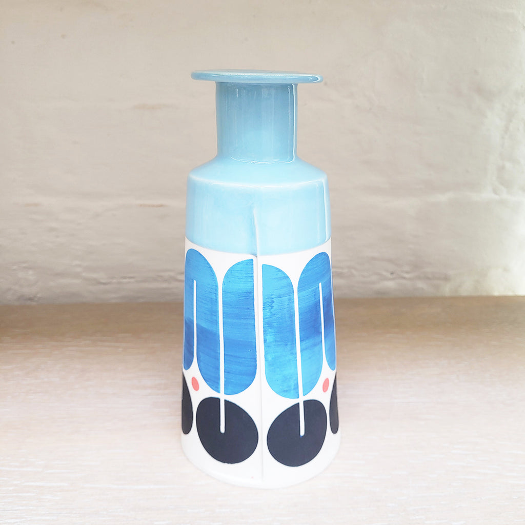 Rear view of Large contemporary ceramic cone bottle by MAP MAP this piece is predominently white background with shades of blue and black in the pattern