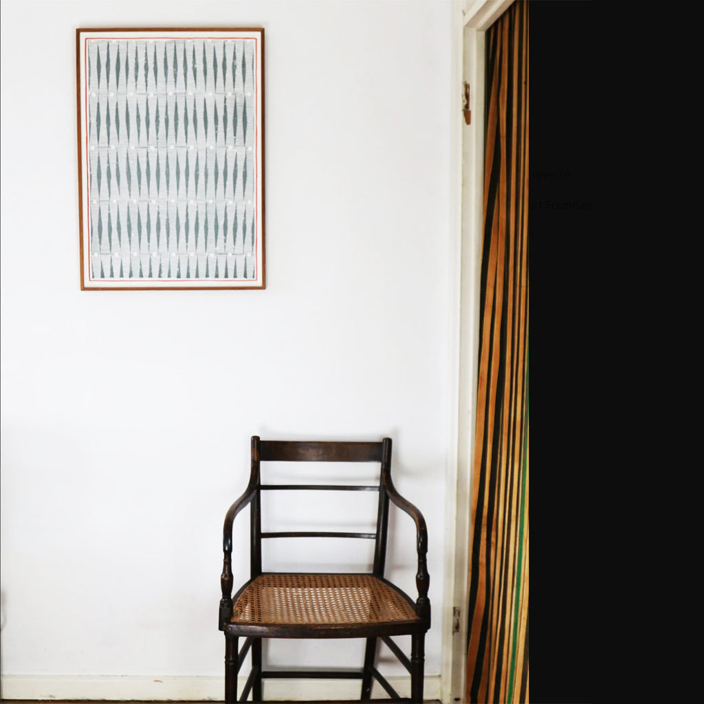 Abstract art print with geometric patternin grey white and red. By artist Louisa Loakes  shown framed and hanging in a room 