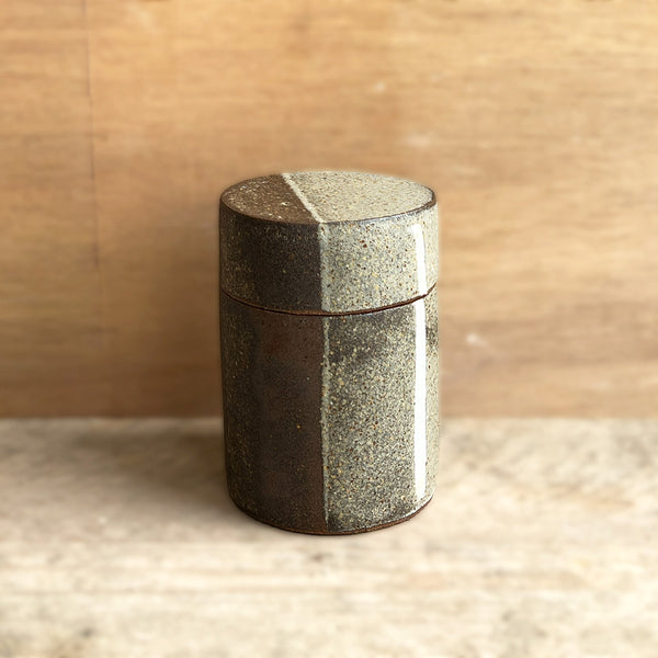 beautiful hand built medium sized stoneare jar with a porcelain inlay and wood ash glaze in the signature design of Contemporary Ceramicist Hannah Sulek